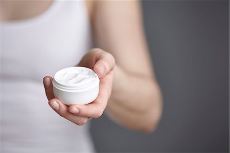 dry skin - Close up cropped shot of young woman holding moisturiser jar Stock Photo - Premium Royalty-Free, Code: 649-08480336