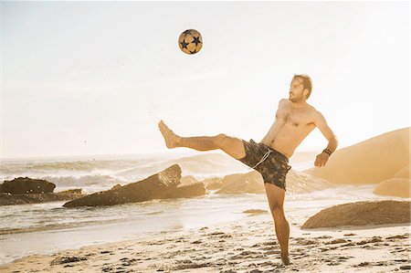 simsearch:6122-07694575,k - Mid adult man playing soccer keepy uppy on beach, Cape Town, South Africa Stock Photo - Premium Royalty-Free, Code: 649-08544026