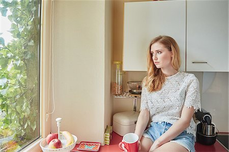 simsearch:649-09078403,k - Young woman looking through window from kitchen counter Stock Photo - Premium Royalty-Free, Code: 649-08544101