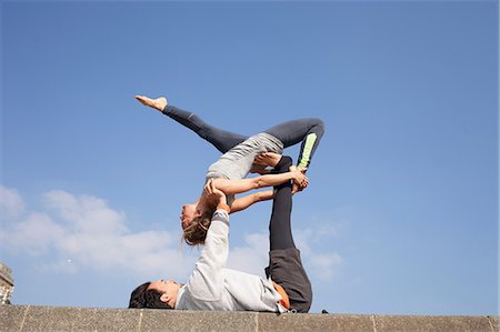 Man and woman on wall practicing acrobatic yoga Stock Photo - Premium Royalty-Free, Code: 649-08544225