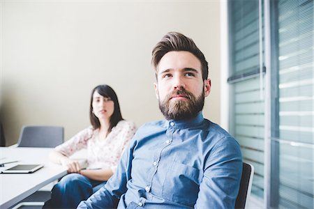 Two young designers listening in boardroom meeting Stock Photo - Premium Royalty-Free, Code: 649-08544263