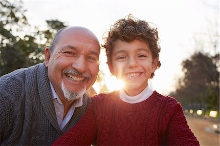 Portrait of grandfather and grandson looking at camera smiling Photographie de stock - Premium Libres de Droits, Code: 649-08544310