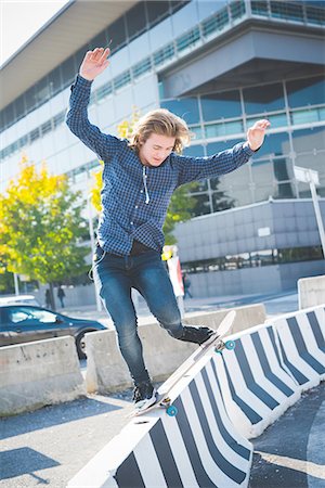 simsearch:614-07194658,k - Young male urban skateboarder balancing on top of concrete barrier Stock Photo - Premium Royalty-Free, Code: 649-08548886