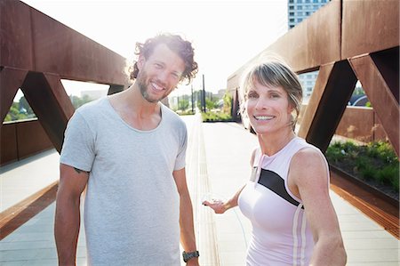 Portrait of mature woman and man training on urban footbridge Stock Photo - Premium Royalty-Free, Code: 649-08543333