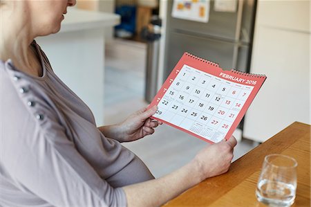 simsearch:649-08144531,k - High angle side view of pregnant woman looking at calendar Stock Photo - Premium Royalty-Free, Code: 649-08543526