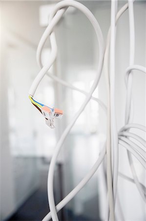 simsearch:6113-06721341,k - Close up of network connection plug and power cables hanging from new office ceiling Stock Photo - Premium Royalty-Free, Code: 649-08543677