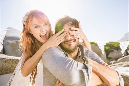 simsearch:649-08543866,k - Woman behind man covering his eyes with hands smiling Stock Photo - Premium Royalty-Free, Code: 649-08543892