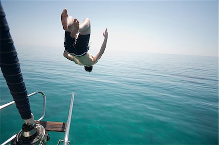 dive boat - Man jumping head first into the sea Stock Photo - Premium Royalty-Free, Code: 649-08564011