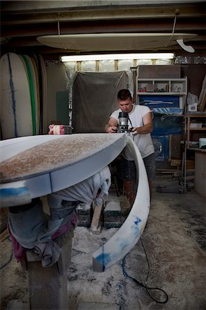 simsearch:6118-08947795,k - Mature man sawing a surfboard in his workshop Stock Photo - Premium Royalty-Free, Code: 649-08565635