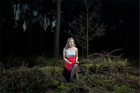 dark forest - Young woman sitting in forest holding a digital tablet Stock Photo - Premium Royalty-Free, Code: 649-08565669