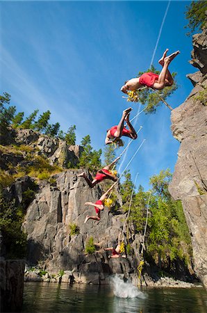 Young man on rope swing and falling into the Goat River near Creston, British Columbia, Canada Stockbilder - Premium RF Lizenzfrei, Bildnummer: 649-08565699