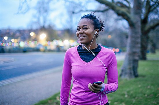 Young woman in exercise clothes, wearing earphones Stock Photo - Premium Royalty-Free, Image code: 649-08566029