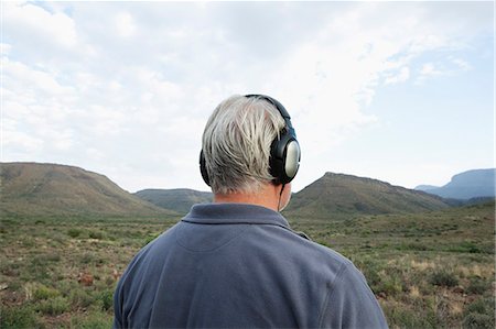 Man listening to music with headphones Stock Photo - Premium Royalty-Free, Code: 649-08560318