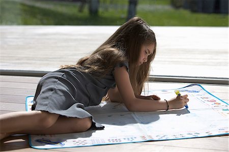 drawing a person lying down - Girl Playing with pen Stock Photo - Premium Royalty-Free, Code: 649-08560341