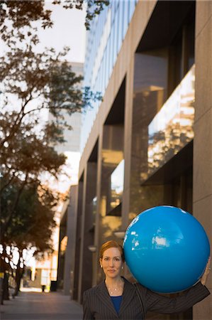 female business woman holding ball - businesswoman holding blue balloon Stock Photo - Premium Royalty-Free, Code: 649-08560576