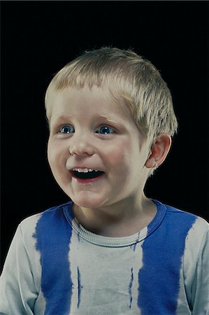 simsearch:649-06113680,k - Close up of boy's smiling face Fotografie stock - Premium Royalty-Free, Codice: 649-08560781
