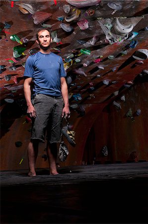 rock climbing indoors full length - Man standing by indoor rock wall Stock Photo - Premium Royalty-Free, Code: 649-08560969