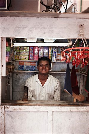 Smiling man working in kiosk Stock Photo - Premium Royalty-Free, Code: 649-08560991