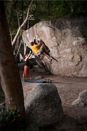 Rock climbers scaling boulder face Stock Photo - Premium Royalty-Free, Code: 649-08561056