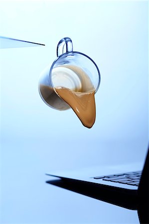 dropped mobile - Coffee cup spilling on laptop Stock Photo - Premium Royalty-Free, Code: 649-08561203