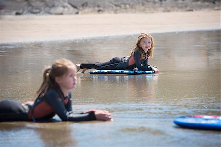 Children on surfboards in water Stock Photo - Premium Royalty-Free, Code: 649-08561280