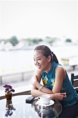 Smiling woman sitting in cafe Stock Photo - Premium Royalty-Free, Code: 649-08561407