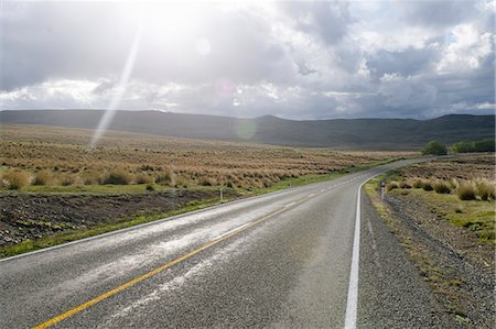 Paved road in rural landscape Fotografie stock - Premium Royalty-Free, Codice: 649-08561585