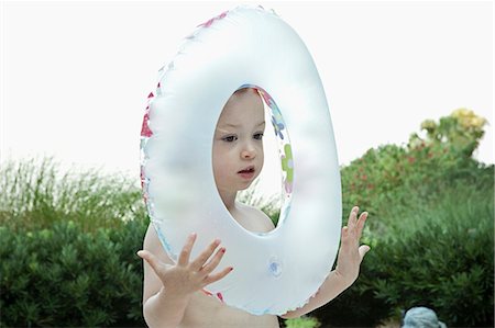 framing face - Girl playing with inflatable tube Stock Photo - Premium Royalty-Free, Code: 649-08561875