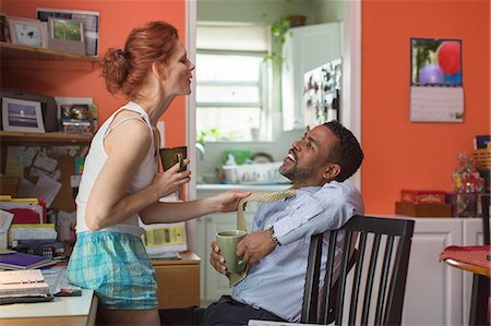romantic with tie - Mature couple in kitchen, woman pulling man's tie Stock Photo - Premium Royalty-Free, Code: 649-08562114