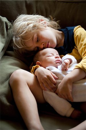Young boy holding baby brother Stock Photo - Premium Royalty-Free, Code: 649-08563039