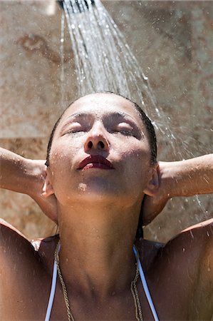 Young woman showering Stock Photo - Premium Royalty-Free, Code: 649-08563374