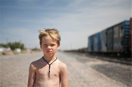 Boy by train tracks Stock Photo - Premium Royalty-Free, Code: 649-08563496