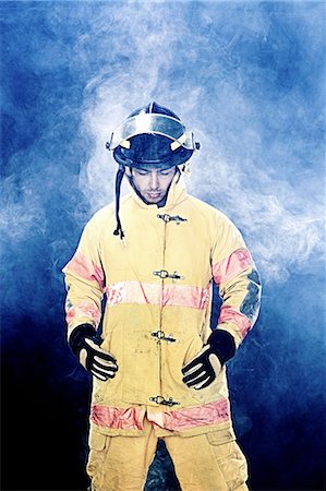 ethnic mid adult firefighter - Portrait of firefighter in smoke Stock Photo - Premium Royalty-Free, Code: 649-08563565