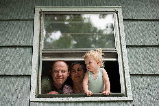 Family looking through window Stock Photo - Premium Royalty-Free, Image code: 649-08563693
