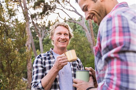 Two male hikers talking over coffee in forest, Deer Park, Cape Town, South Africa Stock Photo - Premium Royalty-Free, Code: 649-08576552