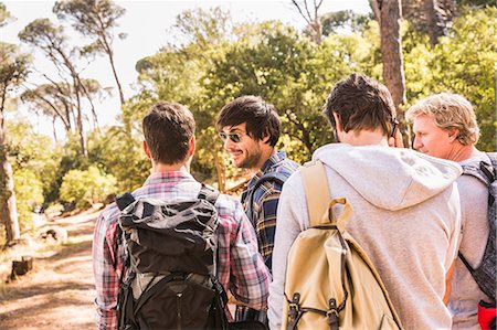 Rear view of man talking on smartphone whilst hiking with friends in forest, Deer Park, Cape Town, South Africa Stock Photo - Premium Royalty-Free, Code: 649-08576593