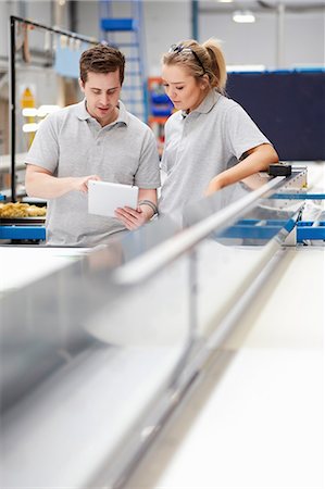 Manager and female worker looking at digital tablet on production line in factory Stock Photo - Premium Royalty-Free, Code: 649-08576617