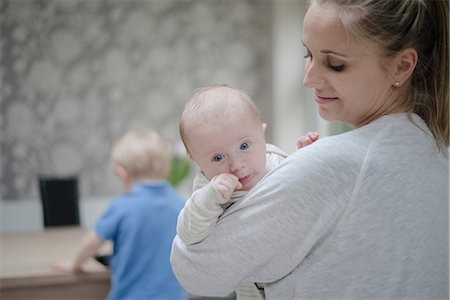 simsearch:649-08576676,k - Mother holding baby boy, older son standing by table Stock Photo - Premium Royalty-Free, Code: 649-08576669