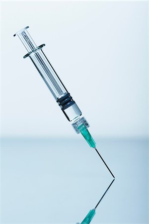 Syringe with needle standing upright Stock Photo - Premium Royalty-Free, Code: 649-08576724