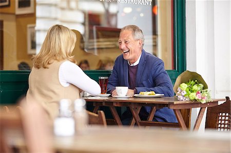 simsearch:614-08879491,k - Mature couple on date laughing together at sidewalk cafe table Stock Photo - Premium Royalty-Free, Code: 649-08577194