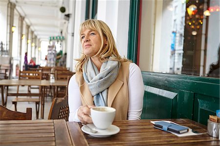 simsearch:649-08969126,k - Mature woman looking out from sidewalk cafe table Stock Photo - Premium Royalty-Free, Code: 649-08577190