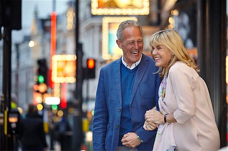 simsearch:649-08577203,k - Mature dating couple giggling on city street at dusk, London, UK Photographie de stock - Premium Libres de Droits, Code: 649-08577219