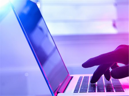 suspicious - Gloved hand hacking laptop computer Stock Photo - Premium Royalty-Free, Code: 649-08577255