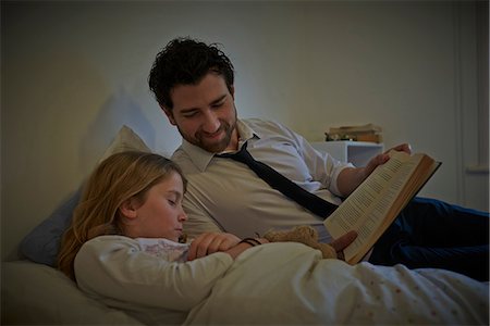 sleeping two child - Businessman reading storybook to sleeping daughter at bedtime Stock Photo - Premium Royalty-Free, Code: 649-08577253