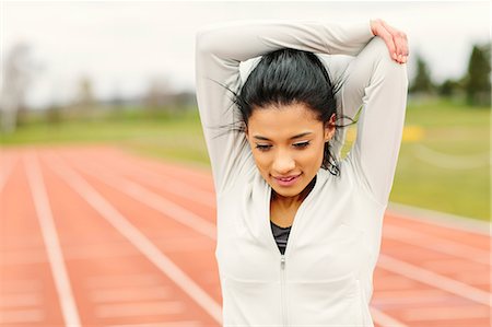simsearch:649-08577265,k - Young woman on running track, exercising, stretching Stock Photo - Premium Royalty-Free, Code: 649-08577280