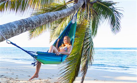 Young woman reclining in palm tree hammock, Dominican Republic, The Caribbean Stock Photo - Premium Royalty-Free, Code: 649-08577316