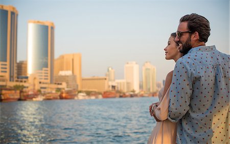 simsearch:649-08577651,k - Romantic couple looking out at Dubai marina, United Arab Emirates Stock Photo - Premium Royalty-Free, Code: 649-08577647