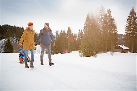 snow kids fun - Parents pulling sons on toboggan in snow landscape, Elmau, Bavaria, Germany Stock Photo - Premium Royalty-Free, Code: 649-08577725