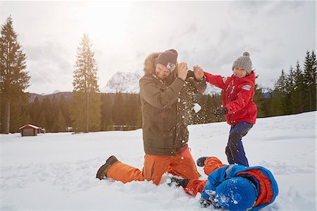 Man and sons having snowball fight in winter, Elmau, Bavaria, Germany Stock Photo - Premium Royalty-Free, Code: 649-08577756