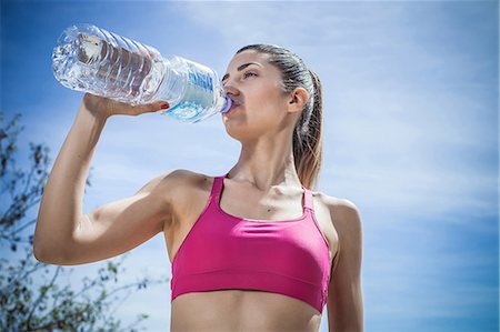 fitness woman healthy food - Woman drinking water from bottle Stock Photo - Premium Royalty-Free, Code: 649-08577914